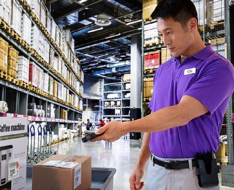 Warehouse colleague scanning stock with a handheld device